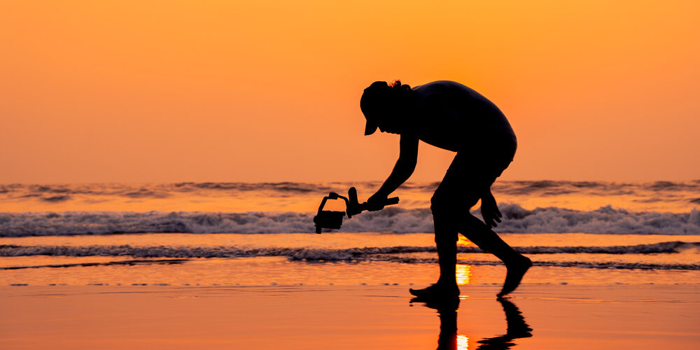 A,Young,And,Independent,Filmmaker,Filming,Near,Beach,Silhouette